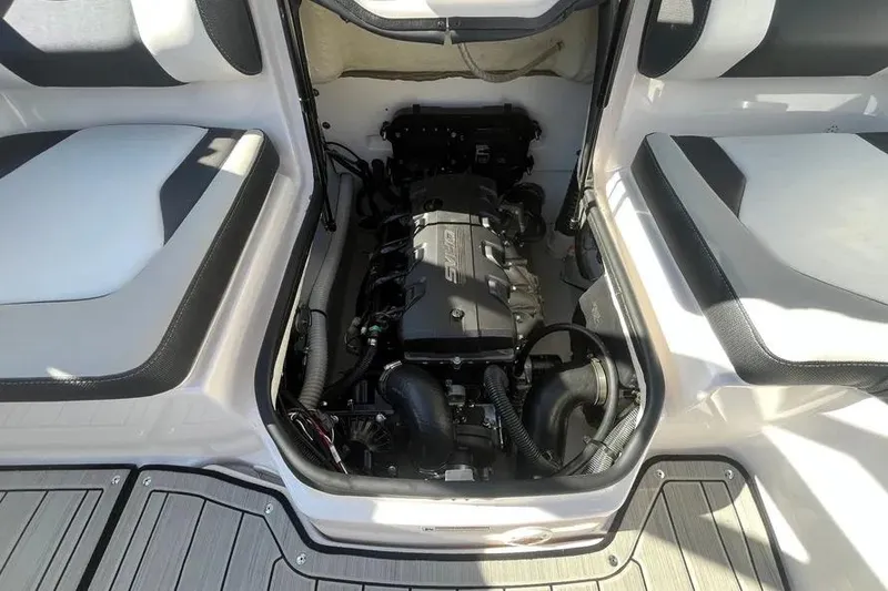 Slide: The Image of 2024 Yamaha Boats 195S engine compartment with seating and deck view. - 13