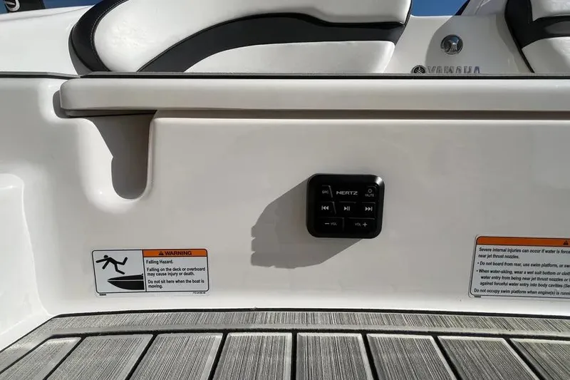 Slide: The Image of 2024 Yamaha Boats 195S deck with control panel and safety warnings. - 17