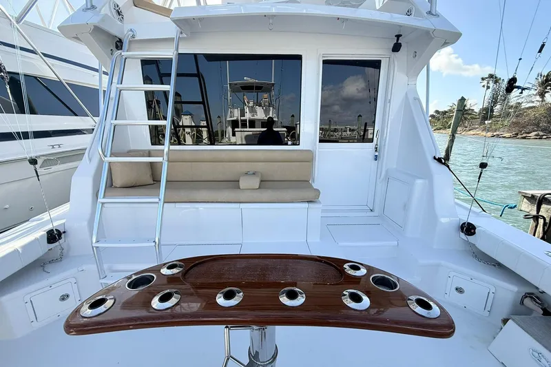 Slide: The Image of 1992 Viking 50 Convertible yacht cockpit with seating, ladder, and rod holders. - 12