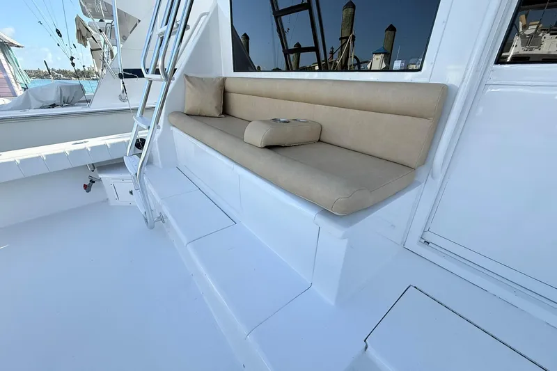 Slide: The Image of 1992 Viking 50 Convertible yacht with beige cushioned seating and ladder on deck. - 13
