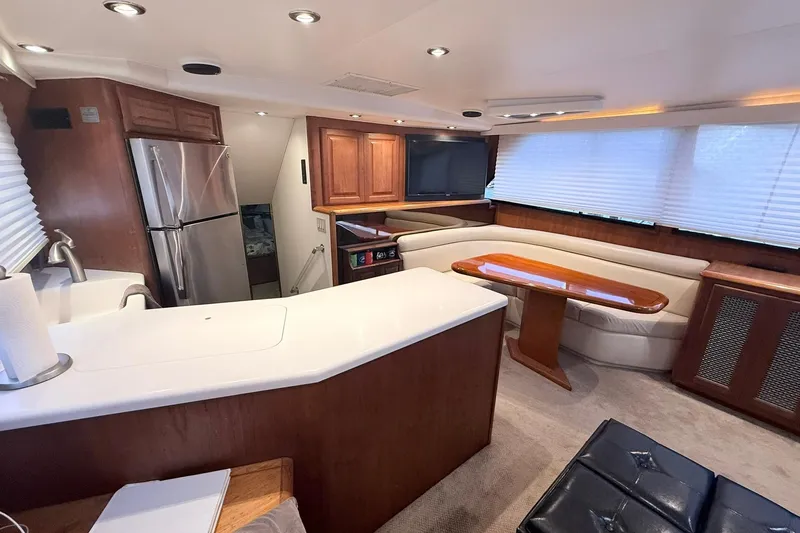 Slide: The Image of Luxurious interior of a 1992 Viking 50 Convertible yacht with modern kitchen and seating area. - 17