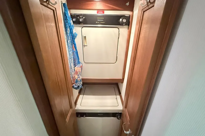 Slide: The Image of Laundry area inside 1992 Viking 50 Convertible yacht with washer and dryer. - 24