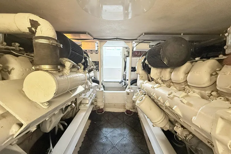 Slide: The Image of Engine room of a 1992 Viking 50 Convertible yacht, showcasing dual engines. - 31