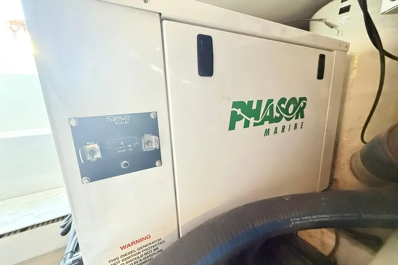 Slide: The Image of Phasor Marine generator inside a 1992 Viking 50 Convertible yacht engine room. - 34