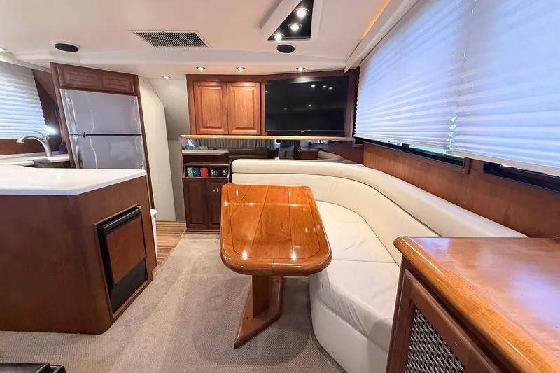 Slide: The Image of Luxurious interior of a 1992 Viking 50 Convertible yacht with wood finishes and modern amenities. - 4