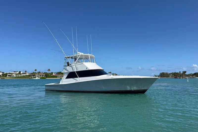 Slide: The Image of 1992 Viking 50 Convertible yacht on calm blue water under clear sky. - 40