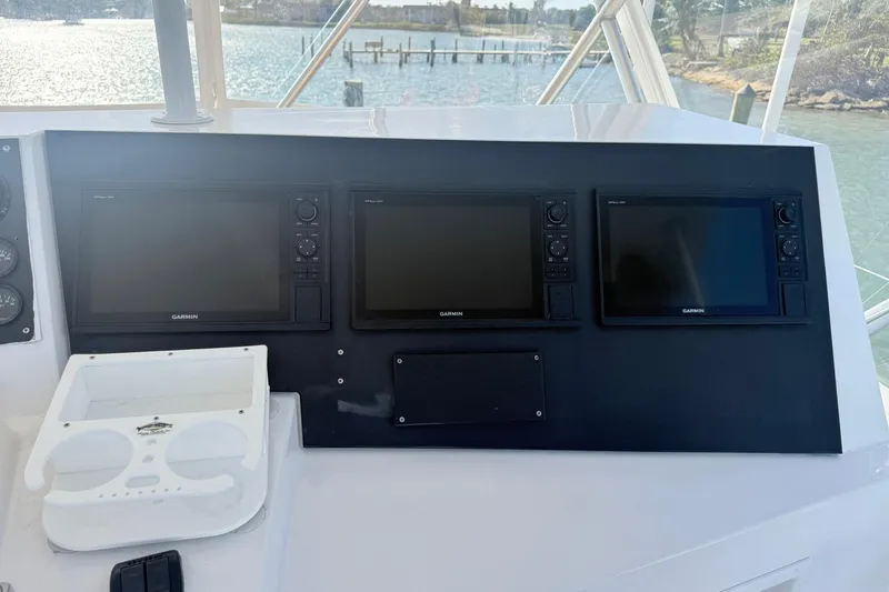 Slide: The Image of 1992 Viking 50 Convertible yacht dashboard with Garmin navigation displays. - 9