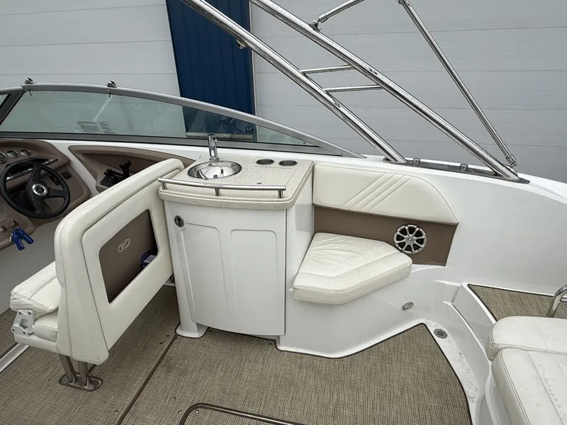 Slide: The Image of Interior of a 2008 Cobalt 303 boat with seating and helm console. - 21