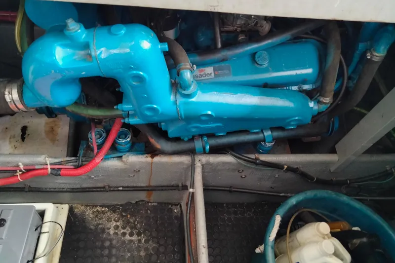 Slide: The Image of Engine compartment of a 1990 Mainship 41 Grand Salon with blue components and wiring. - 12