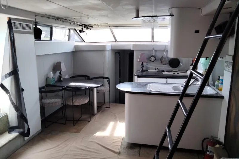 Slide: The Image of Interior of 1990 Mainship 41 Grand Salon yacht with kitchen and dining area. - 3