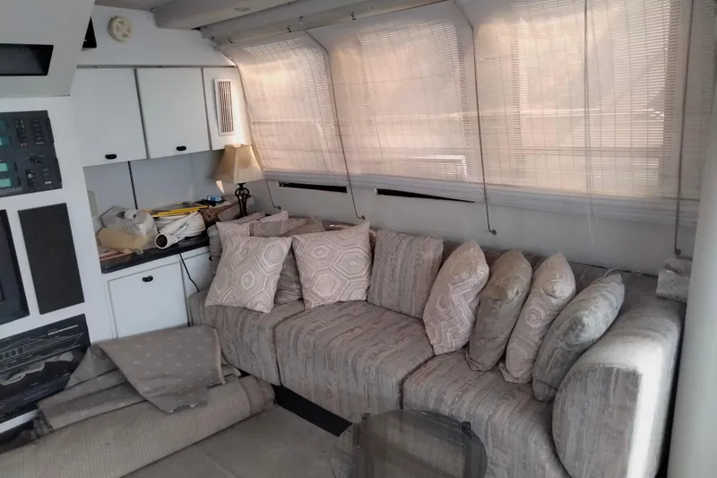 Slide: The Image of Interior of 1990 Mainship 41 Grand Salon with cozy sofa and decorative pillows. - 4