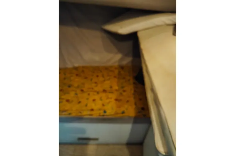 Slide: The Image of 1990 Mainship 41 Grand Salon interior cabin with yellow bedding. - 7