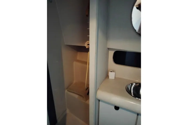 Slide: The Image of 1990 Mainship 41 Grand Salon bathroom with shower and sink area. - 9