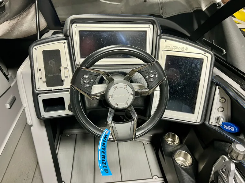Slide: The Image of Interior of a 2021 Supra SE 450 with steering wheel and displays. - 12