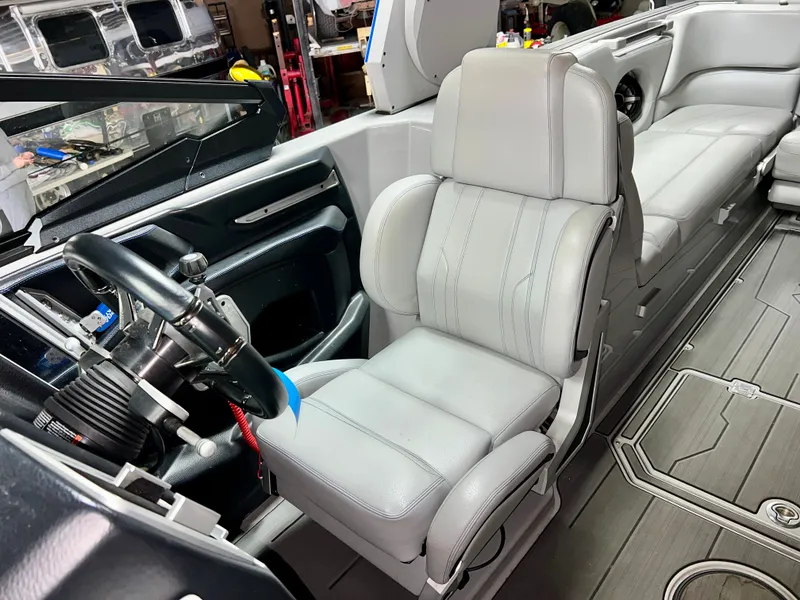 Slide: The Image of Interior of a 2021 Supra SE 450 boat with steering wheel and seat. - 14