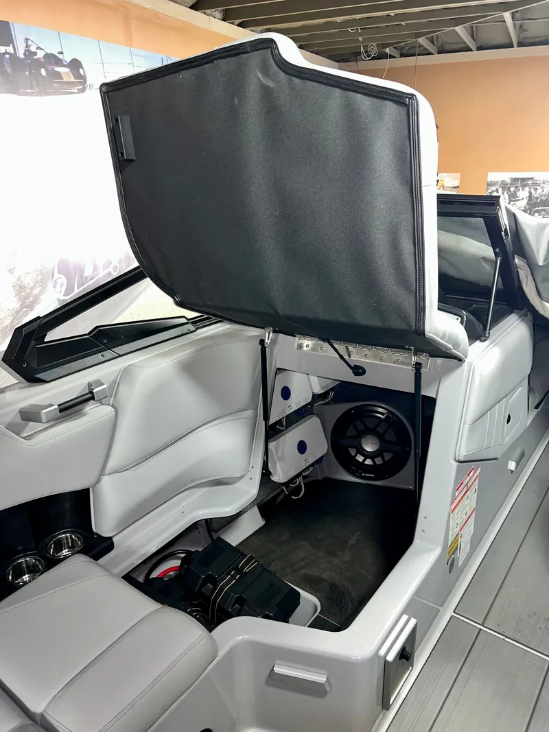 Slide: The Image of Interior of a 2021 Supra SE 450 boat with open storage compartment. - 18