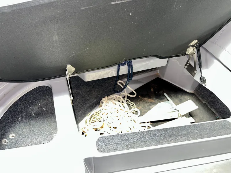 Slide: The Image of Storage compartment in 2021 Supra SE 450 boat with anchor and rope. - 21