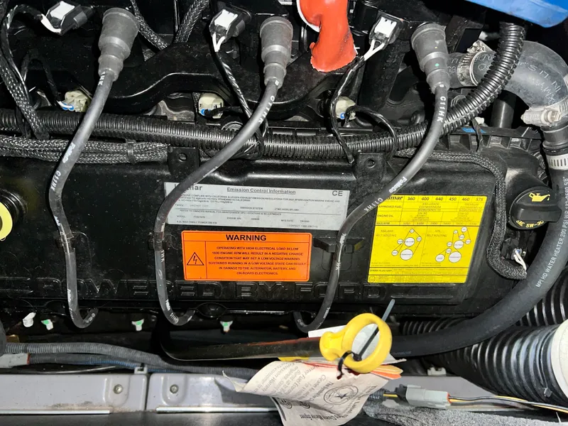 Slide: The Image of Engine compartment of a 2021 Supra SE 450 with warning labels. - 35