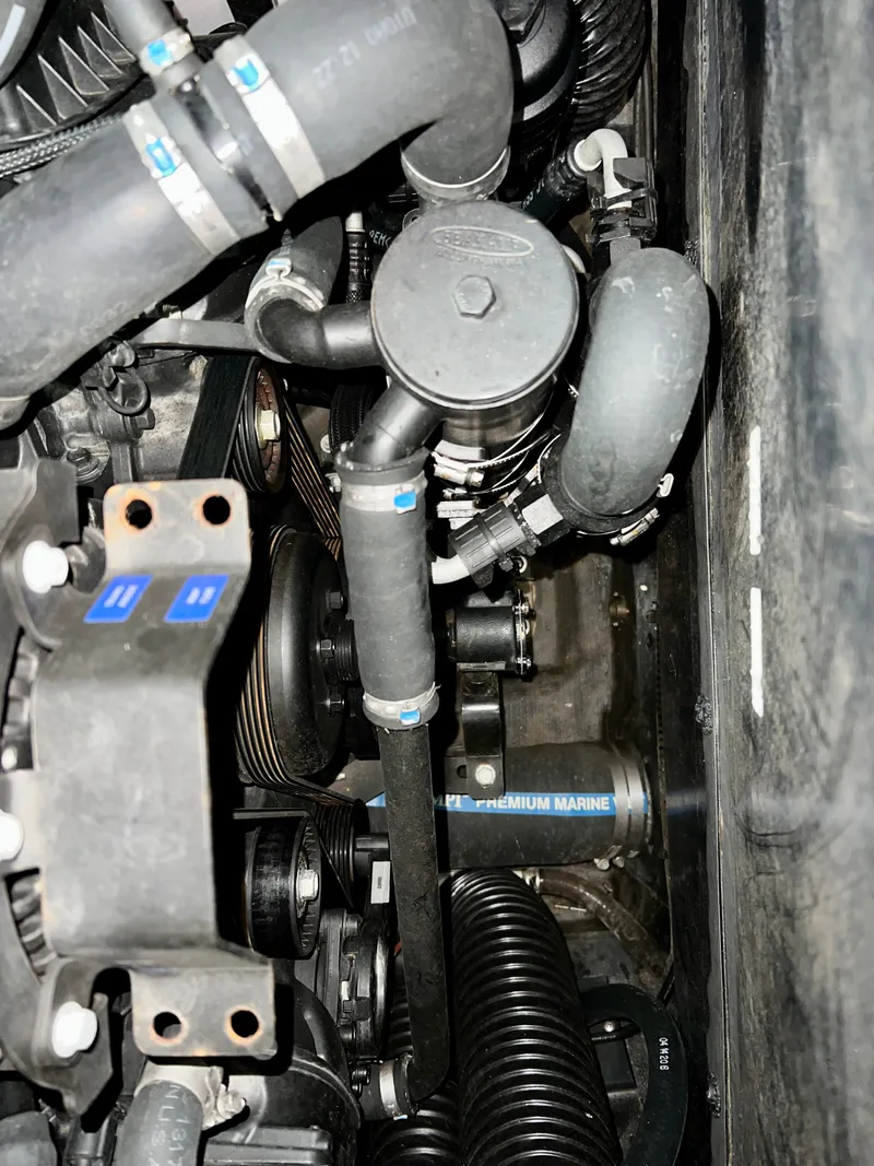 Slide: The Image of Engine compartment of 2021 Supra SE 450 with hoses and components. - 36