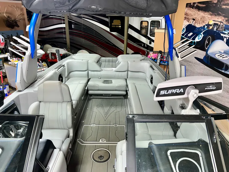 Slide: The Image of Interior of a 2021 Supra SE 450 boat with gray seating. - 9