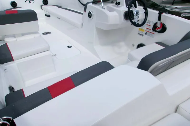 Slide: The Image of 2026 Tahoe T18 boat interior with sleek white and gray seating, red accents, and modern steering. - 5