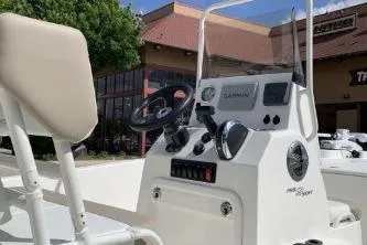 Slide: The Image of 2026 Mako Pro Skiff 19 CC boat console with steering wheel and controls. - 3