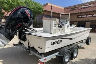 Slide: The Image of 2026 Mako Pro Skiff 19 CC boat on trailer, parked outside Tracker Boat Center. - 4