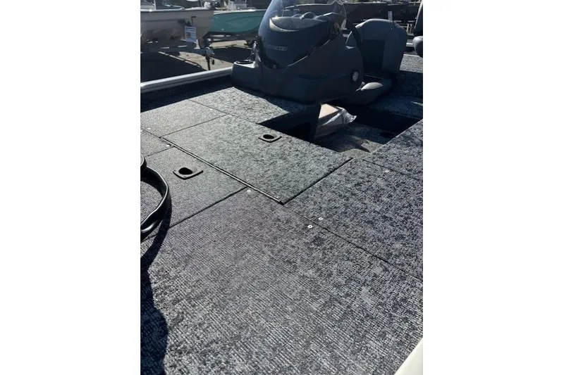 Slide: The Image of 2026 Tracker Pro 170 boat interior with carpeted deck and steering console. - 10