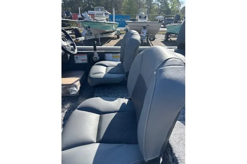 Slide: The Image of 2026 Tracker Pro 170 boat interior with gray seating in a sunny outdoor setting. - 11
