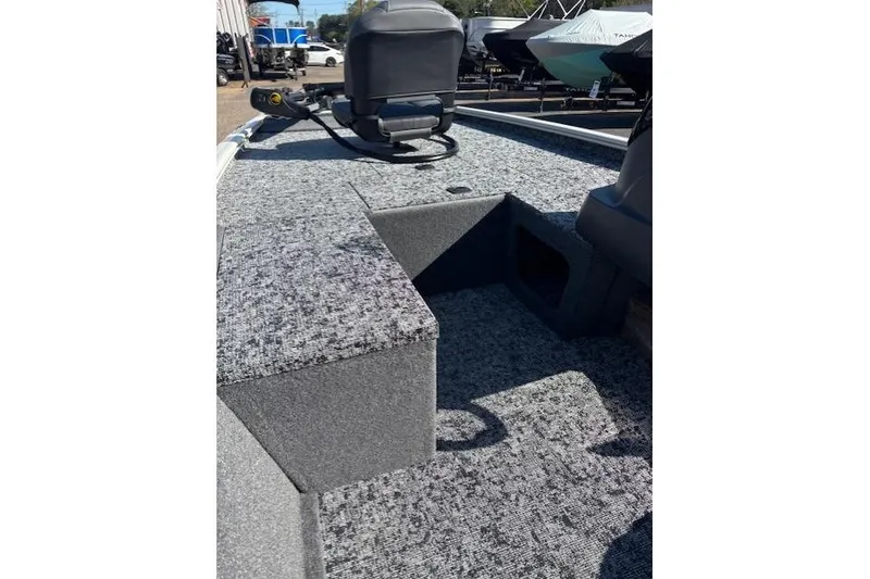 Slide: The Image of 2026 Tracker Pro 170 boat interior with gray carpet and seating. - 13