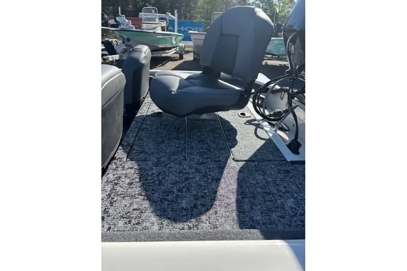 Slide: The Image of 2026 Tracker Pro 170 boat interior with cushioned seating and carpeted flooring. - 14