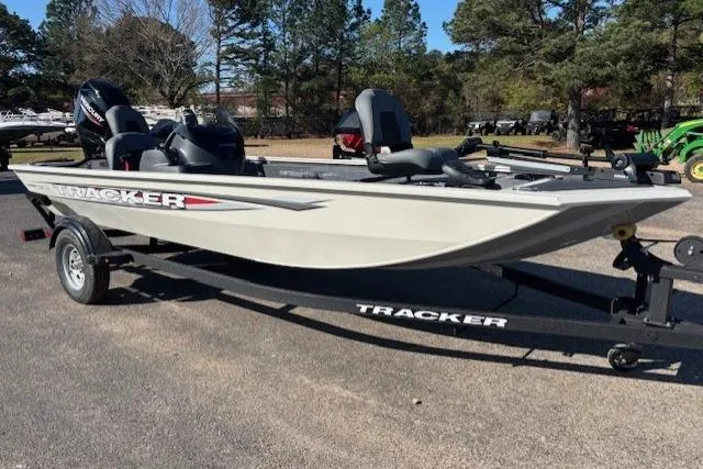 Slide: The Image of 2026 Tracker Pro 170 boat on trailer, parked outdoors, surrounded by trees. - 6