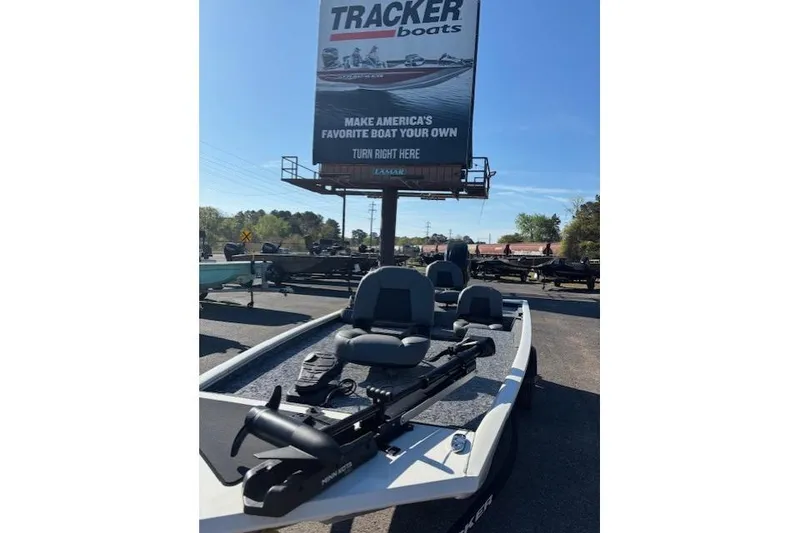 Slide: The Image of 2026 Tracker Pro 170 boat displayed outdoors under a Tracker Boats sign. - 9