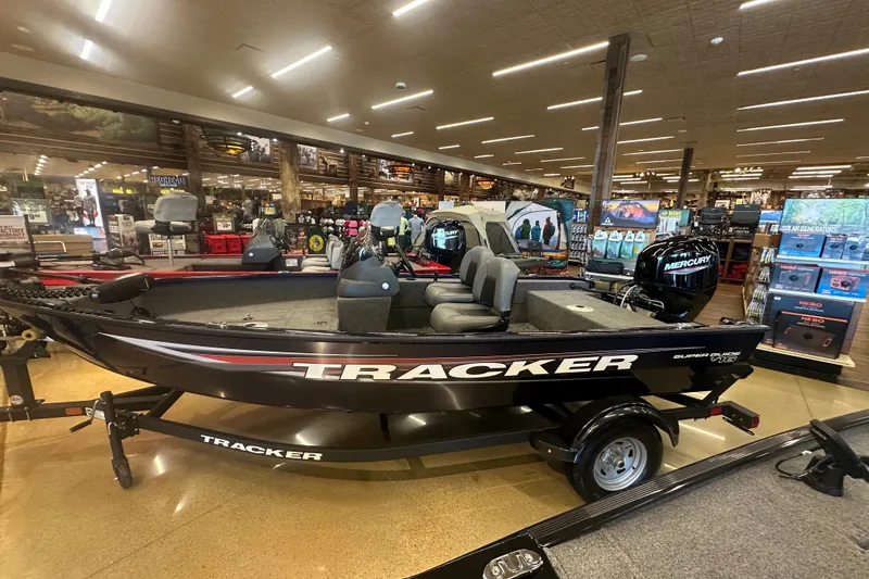 The Image of 2026 Tracker Super Guide V-16 SC boat displayed in a showroom. - 9