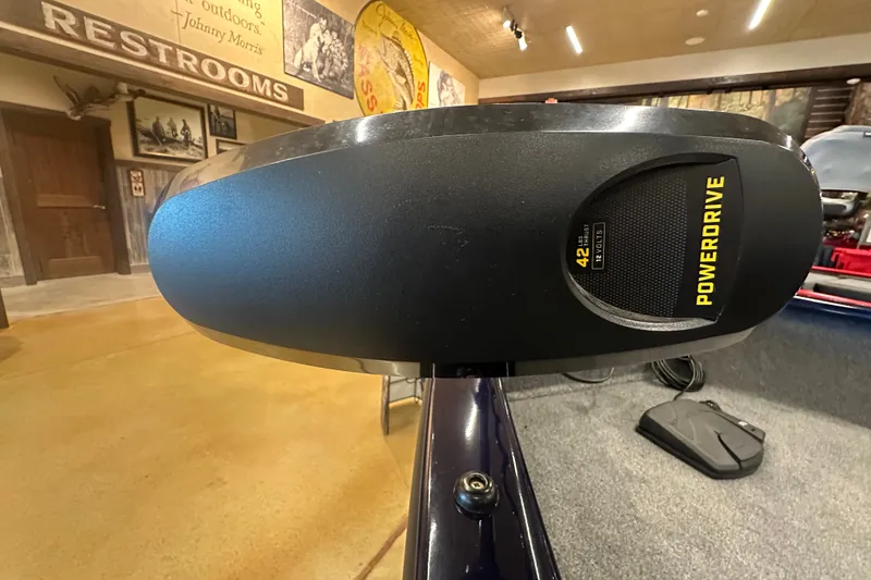Slide: The Image of PowerDrive motor on 2026 Tracker Super Guide V-16 SC boat, indoor showroom display. - 24