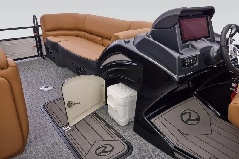 Slide: The Image of 2026 Regency 230 DL boat interior with tan seating, open storage compartment, and modern dashboard. - 20