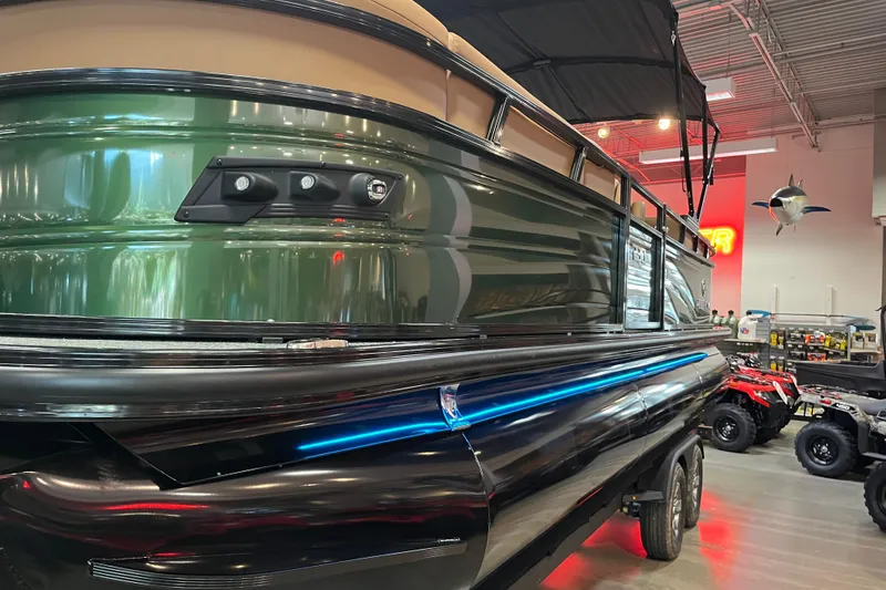 Slide: The Image of 2026 Regency 230 DL pontoon boat displayed indoors with sleek design and modern features. - 3