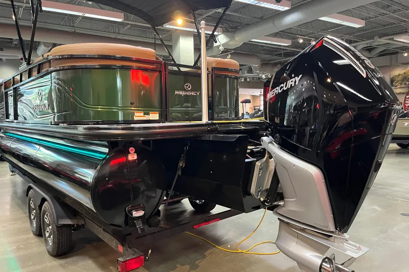 Slide: The Image of 2026 Regency 230 DL boat with Mercury engine displayed indoors. - 6