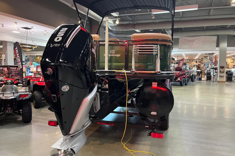 Slide: The Image of 2026 Regency 230 DL boat with powerful 250 V8 engine displayed indoors. - 7