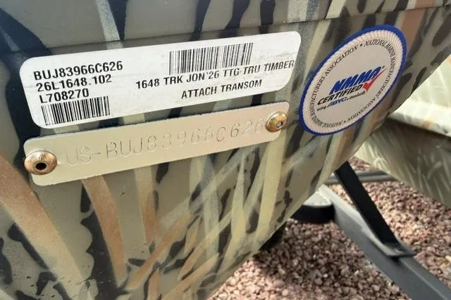 Slide: The Image of 2026 Tracker Grizzly 1648 Utility boat with identification labels and certification sticker. - 5