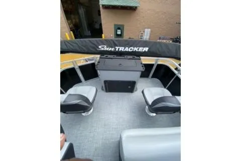 Slide: The Image of 2026 Sun Tracker SportFish 20 DLX pontoon boat interior with seating and storage. - 13