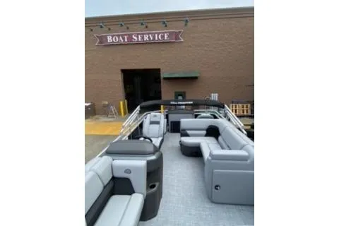 Slide: The Image of 2026 Sun Tracker SportFish 20 DLX pontoon boat at service center. - 14