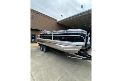 Slide: The Image of 2026 Sun Tracker SportFish 20 DLX pontoon boat on trailer outside a building. - 16