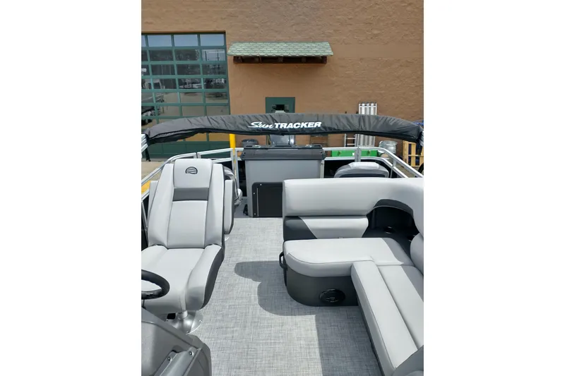 Slide: The Image of 2026 Sun Tracker SportFish 20 DLX pontoon boat with spacious seating and canopy. - 17