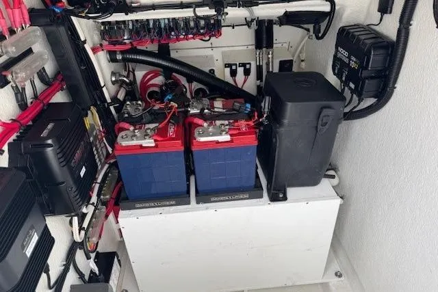 Slide: The Image of 2024 Pair Customs 27 Center Console boat battery compartment with wiring and components. - 11