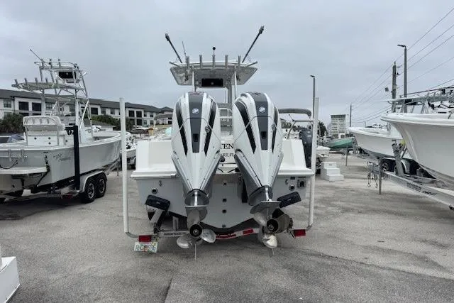 Slide: The Image of 2024 Pair Customs 27 Center Console boat with dual outboard engines, docked in a marina. - 3