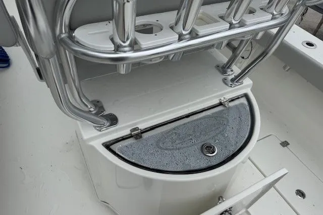 Slide: The Image of 2024 Pair Customs 27 Center Console boat interior with rod holders and storage compartment. - 6