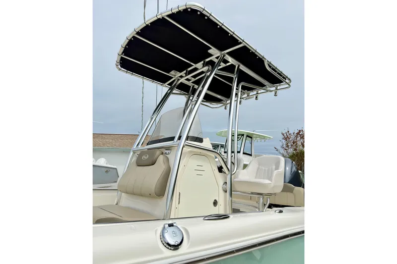 Slide: The Image of 2023 Key West 189 FS boat with T-top and seating, showcasing modern design. - 13