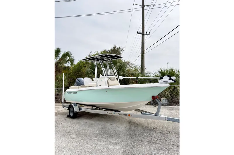Slide: The Image of 2023 Key West 189 FS boat on trailer, parked outdoors. - 14