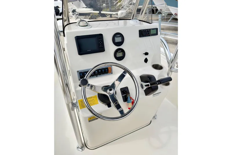 Slide: The Image of 2023 Key West 189 FS boat console with steering wheel and navigation controls. - 5